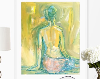 May include: A framed abstract painting of a person sitting with their back to the viewer. The painting is done in shades of yellow, green, blue, and pink.