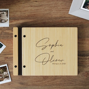 Custom bamboo wedding guest book in a natural finish, personalized with the couples names and event date engraved in the cover.