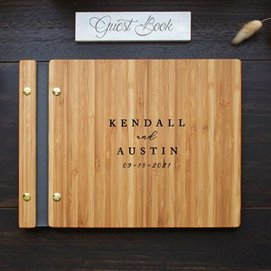 Custom wood wedding guest book in an amber finish, personalized with the bride and grooms names and event date engraved on the cover.