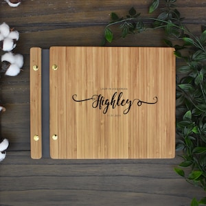 Personalized wooden first wedding anniversary album in an amber finish, customized with the couples names and the anniversary date engraved on the cover.