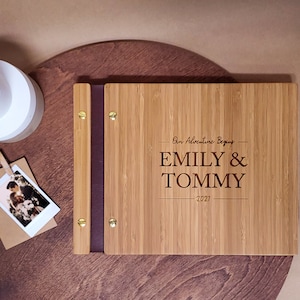 Customized, minimalist bamboo wedding guest book in an amber finish, featuring the couples first and last names and event date engraved in the cover.