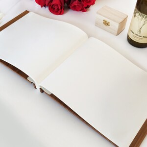 An open view of our boho wedding photo album, showing the white pages throughout, perfect for attaching photos and writing messages.