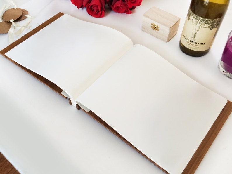 An open view of our boho wedding photo album, showing the white pages throughout, perfect for attaching photos and writing messages.