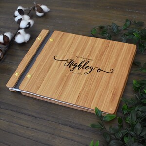 Personalized bamboo first wedding anniversary album in an amber finish, customized with the couples names and the anniversary date engraved on the cover.