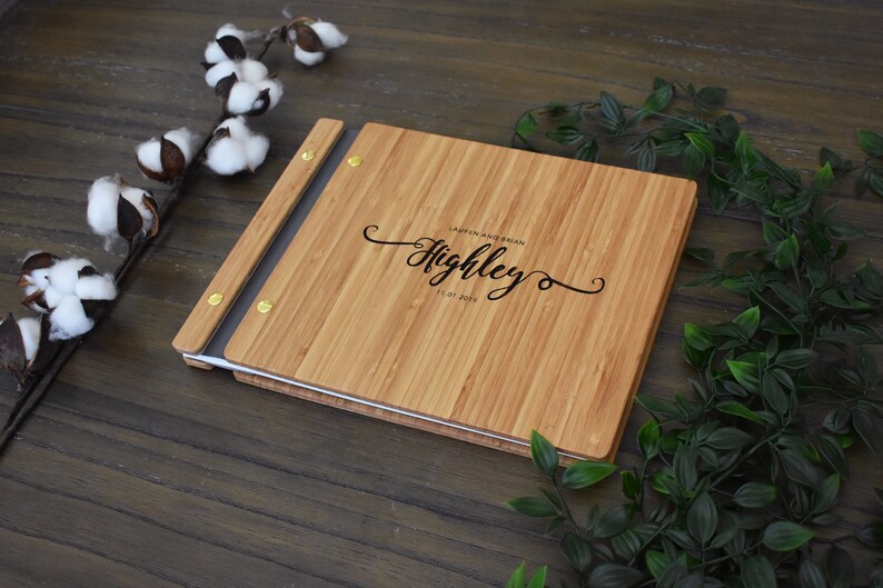 Personalized bamboo first wedding anniversary album in an amber finish, customized with the couples names and the anniversary date engraved on the cover.