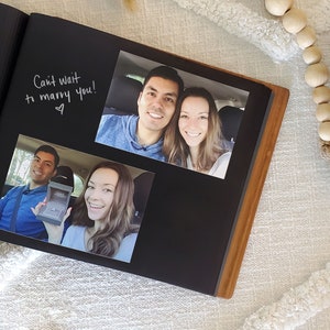 Close-up of interior of our wedding guest book album, featuring photos attached to archival black paper and messages written alongside.