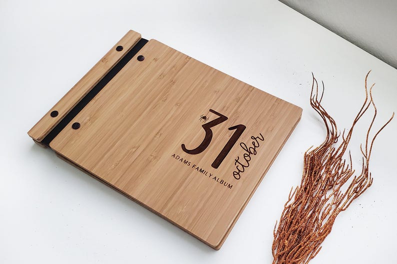 Personalized bamboo Halloween photo scrapbook album in an amber finish, customized with family names engraved on the cover.