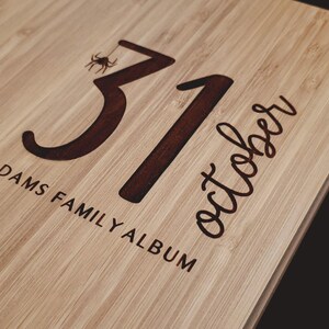 A close-up image showing the Halloween date and a small spider detail engraved on the cover, as well as personalized text below.
