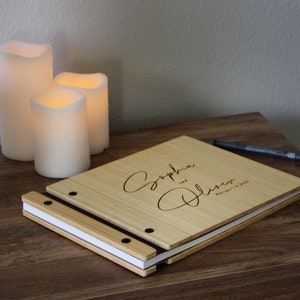 Personalized wooden wedding guest photo album, customized with the bride and grooms names and event date engraved on the cover.