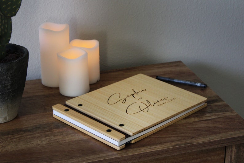 Personalized wooden wedding guest photo album, customized with the bride and grooms names and event date engraved on the cover.