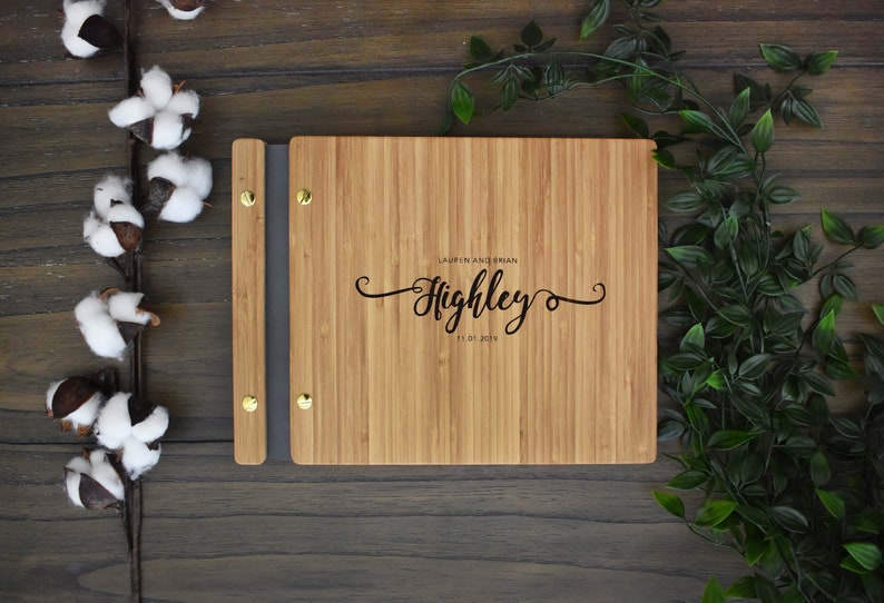 Personalized wooden first wedding anniversary album in an amber finish, customized with the couples names and the anniversary date engraved on the cover.