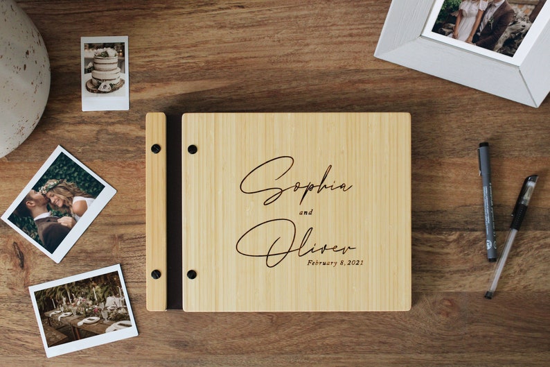 Custom bamboo wedding guest book in a natural finish, personalized with the couples names and event date engraved in the cover.