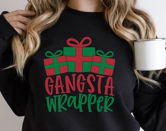 May include: Black sweatshirt with a green and red Christmas gift design and the text "Gangsta Wrapper".