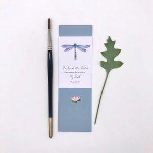 May include: A blue bookmark with a watercolour illustration of a dragonfly, a pink water lily, and the text "He leads Me beside quiet waters, he refreshes My Soul Psalm 23:2-3".