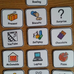 May include: A set of 12 colourful square cards with images and text. The cards feature activities like bowling, biscuits, surprise, YouTube, softplay, chocolate, McDonalds, laptop, pizza, DVD, money, and messy play.