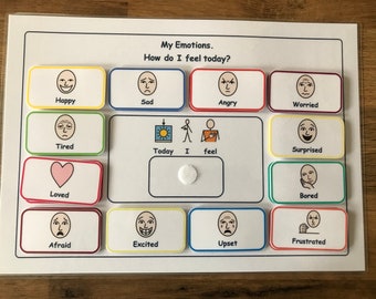 May include: A white board with colorful squares, each containing a different facial expression. The squares are labeled with words describing emotions, such as "Happy", "Sad", "Angry", "Worried", "Tired", "Loved", "Afraid", "Excited", "Upset", "Frustrated", "Surprised", and "Bored". The board also includes the words "Today", "I", and "feel".
