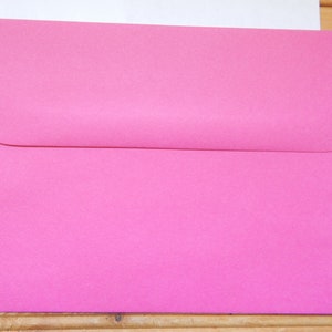 May include: A bright pink envelope.