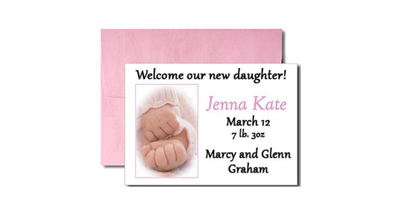 May include: A white card with a pink envelope announcing the birth of a baby girl named Jenna Kate. The card includes the baby's birthdate, weight, and the parents' names: Marcy and Glenn Graham.