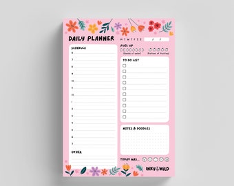 May include: A pink daily planner with a floral border. The planner has sections for schedule, fuel up, to do list, notes & doodles, and other. It also includes a section for today was... with a row of emojis.