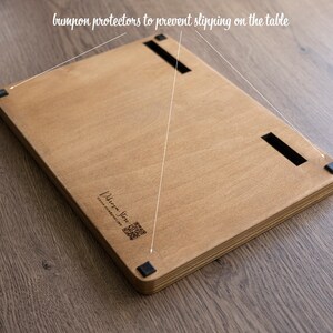 May include: A wooden board with black rubber bumpers on the bottom to prevent slipping on a table. The board has a laser-engraved logo that says "Urban Jive" and a website address.