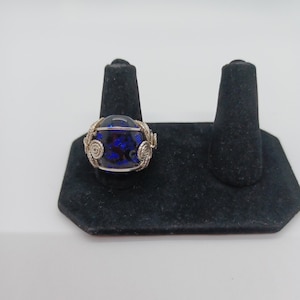Sterling silver wire wrapped ring with a dichroic glass cabochon