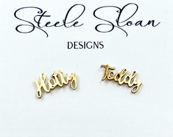 May include: Gold-colored earrings with the names "Holly" and "Teddy" written in cursive.