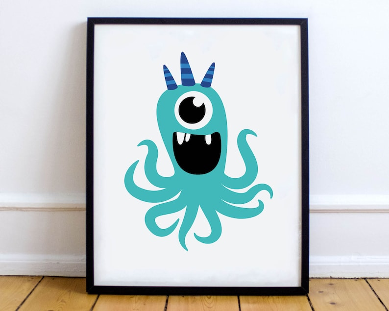 May include: A framed print featuring a cartoon monster with a teal body, one large eye, and a wide, toothy grin. The monster has blue horns and tentacles. The artwork is set against a white background and framed in black, suitable for children's room decor.
