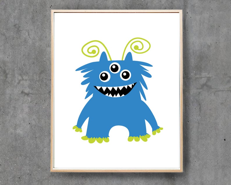 May include: A framed print featuring a cartoon monster. The monster is blue with three eyes, a wide grin with sharp teeth, and green curly antennae. Its feet and hands are also green. The background is white.