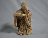 Hand carved Japanesse netsuke elder with wine bowl circa 1950s signed resin