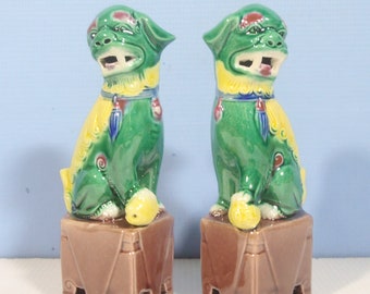 Vintage Chinese porcelain foo dogs one pair green yellow circa mid to late 20th Century unused from old stock