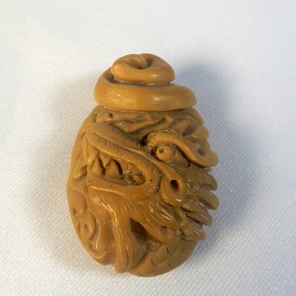 Vintage intricate tagua nut netsuke hand carved dragon circa mid 20th Century retired