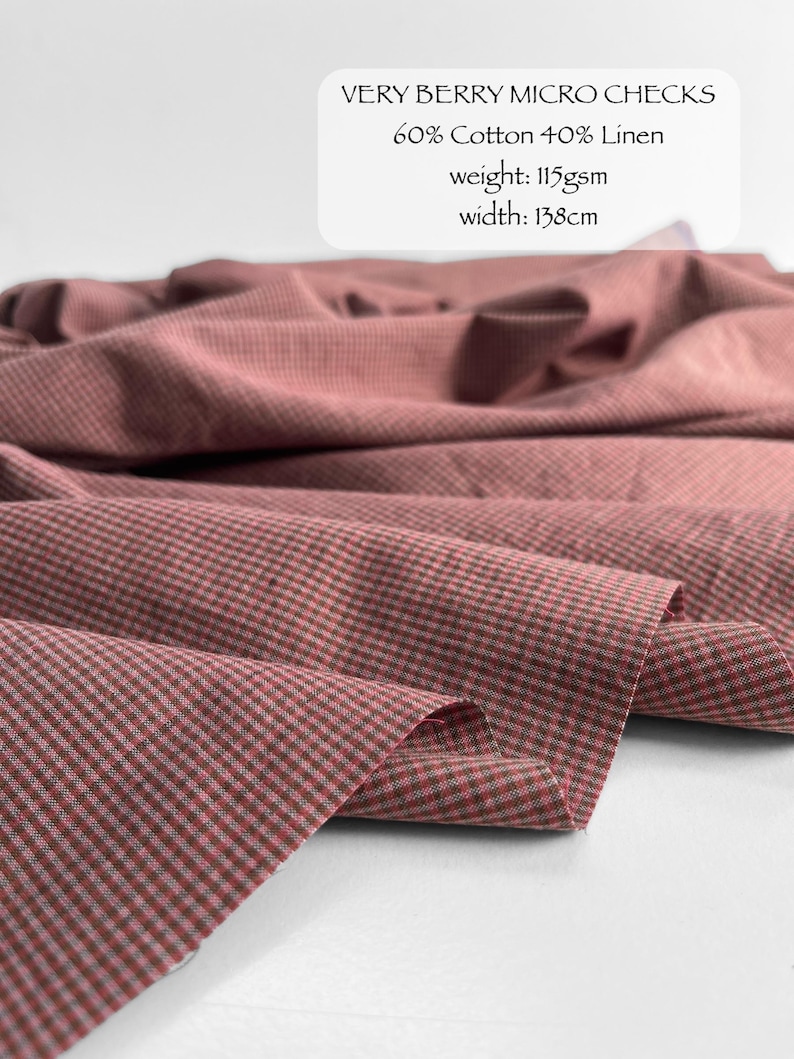 May include: Fabric with a very berry micro check pattern, composed of 60% cotton and 40% linen. The material has a weight of 115gsm and a width of 138cm. The textile features a small-scale checkered design in muted reddish-pink and dark tones.