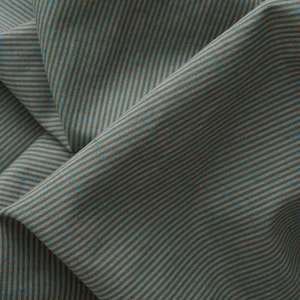 May include: A piece of fabric featuring a fine, repeating pinstripe pattern in alternating shades of muted teal and warm brown. The material is draped to show soft folds and shadows, highlighting the consistent vertical line texture throughout.