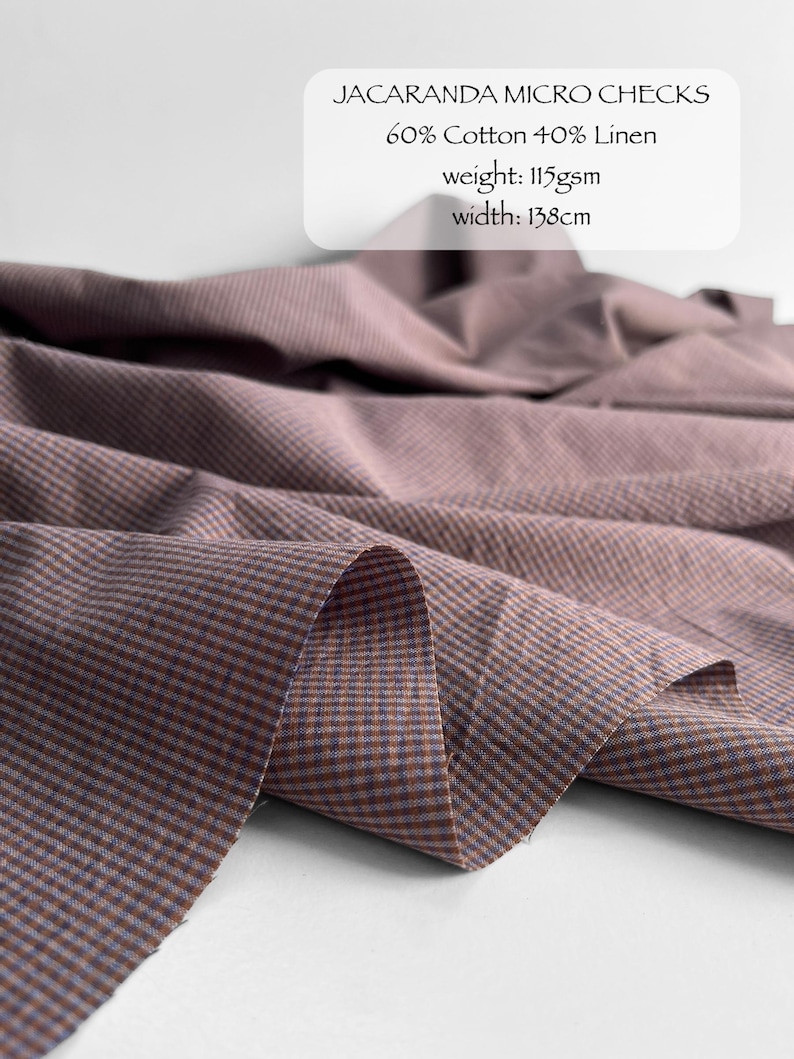 May include: Jacaranda micro checks fabric featuring a blend of 60% cotton and 40% linen. The material has a weight of 115gsm and a width of 138cm. The textile displays a fine, repeating checkered pattern in muted mauve and brown tones.