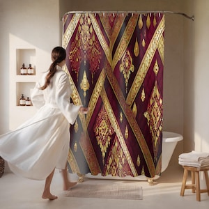 May include: A patterned shower curtain in burgundy and gold. The design features a diamond pattern with gold detailing on a dark burgundy background. The curtain is hanging in a bathroom setting.