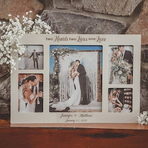 May include: A white wooden picture frame with five openings for photos. The frame has the text "two Hearts two Lives one Love" and "Jennifer & Matthew January 23, 2022" engraved on it. The frame is filled with wedding photos.