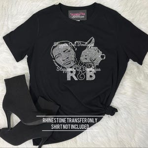 May include: Black t-shirt with a rhinestone design featuring two faces and the letters "R&B". The shirt has short sleeves and is styled with black ankle boots. The text "RHINESTONE TRANSFER ONLY SHIRT NOT INCLUDED" is at the bottom.