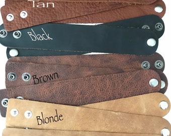 May include: Five leather bracelets in different colours: tan, black, brown, blonde, and tan. Each bracelet has two silver snaps.