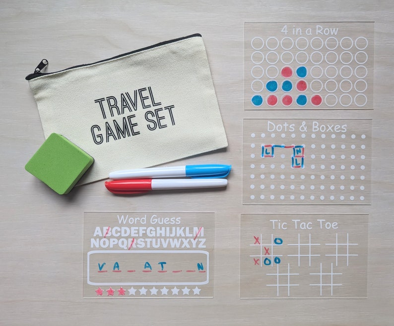 May include: A travel game set with a canvas pouch labeled "TRAVEL GAME SET". Includes a green eraser, red and blue markers, and clear game boards for "4 in a Row", "Dots & Boxes", "Word Guess", and "Tic Tac Toe".