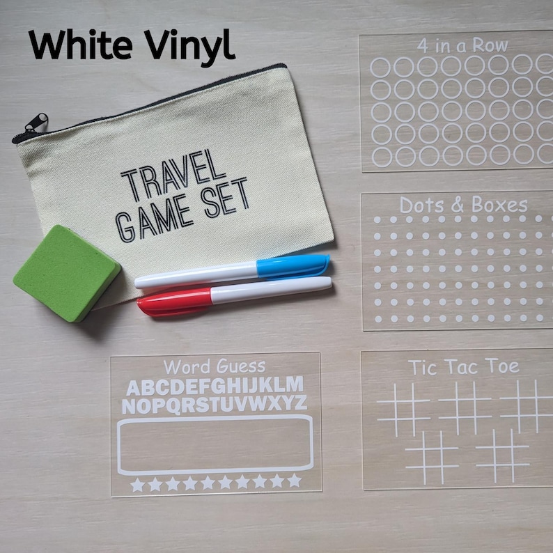 May include: A travel game set with a canvas pouch, eraser, and markers. Includes clear acrylic game boards for 4 in a Row, Dots & Boxes, Word Guess, and Tic Tac Toe. The pouch reads "TRAVEL GAME SET."