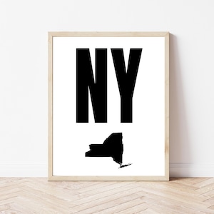 May include: A set of three ceramic mugs with a speckled, matte finish. The mugs are in shades of cream, light gray, and dark gray. Each mug has a simple, minimalist design, perfect for coffee or tea.