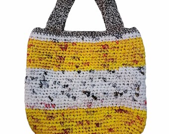 May include: A small yellow, white, and gray crocheted tote bag with a striped pattern. The bag has two short handles.