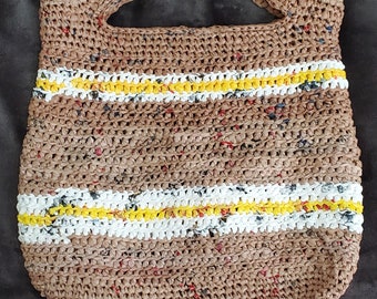 May include: A brown crocheted tote bag with yellow and white stripes. The bag is made from recycled materials.