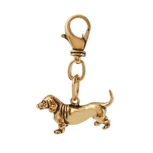 May include: A gold-colored dachshund charm with a spring clasp. The charm is attached to a gold-colored chain.