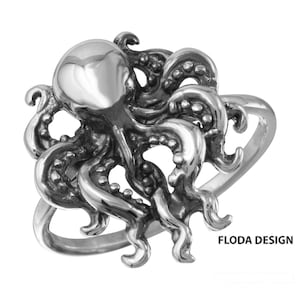 May include: A silver octopus ring with detailed tentacles. The ring is made of sterling silver and features a realistic octopus design. The octopus is positioned on the ring band with its tentacles extending upwards. The ring is a statement piece and would make a great gift for anyone who loves the ocean.