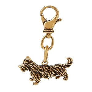 May include: Gold-toned metal keychain featuring a detailed, three-dimensional sculpture of a terrier dog.