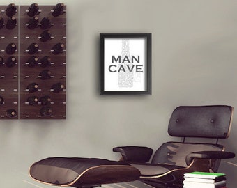 May include: A modern living room interior with a brown leather armchair and ottoman, a wooden floor, a white cowhide rug, a telescope, and a wall-mounted wine rack with a brown and orange wood finish. The wall also features a framed print with the text "MAN CAVE".