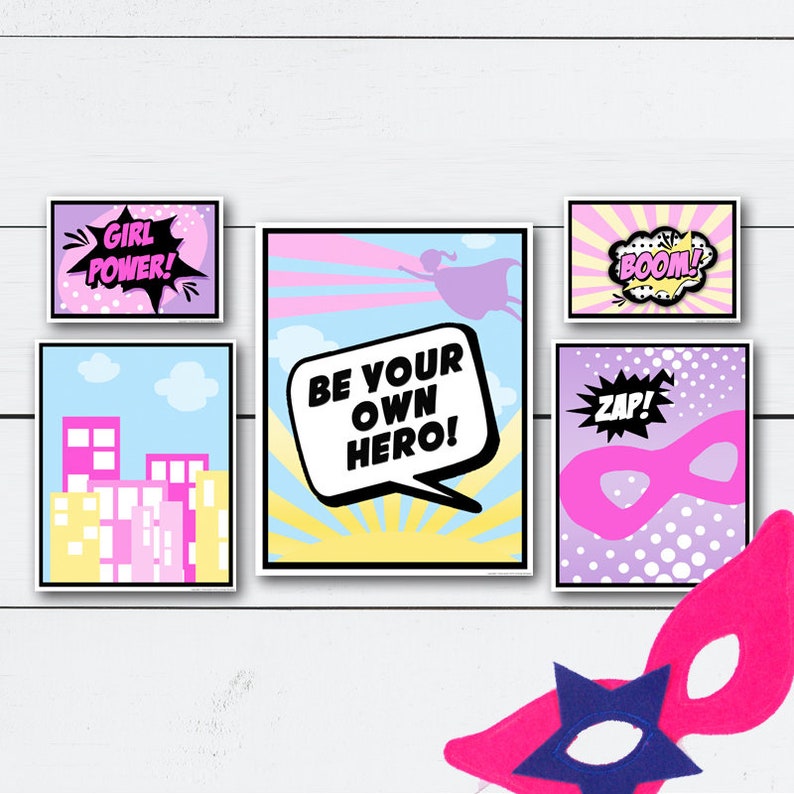 May include: Five printable posters with a superhero theme. The posters feature a pink and blue color scheme with text that says "Girl Power!" "Be Your Own Hero!" "Boom!" "Zap!" and a silhouette of a superhero flying.