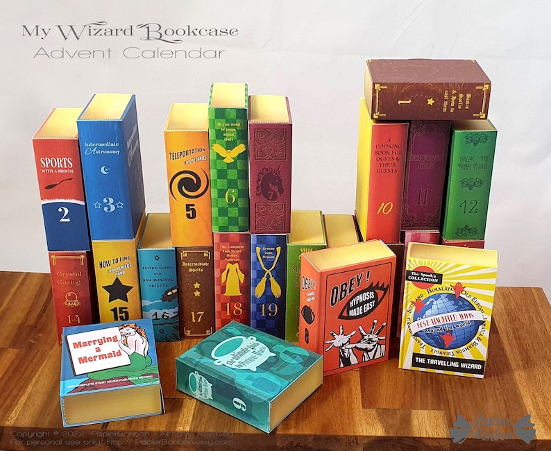 May include: A colorful advent calendar made to look like a bookcase with a wizard theme. Each book is numbered from 1 to 19 and has a different title, such as "Sports with a Broomstick", "Intermediate Alchemy", "Teleportation", "Cooking Book for Ogres & Their Guests", "How to Find a Wonderful Elf", "Marrying a Mermaid", and "Obey! Hypnosis Made Easy".