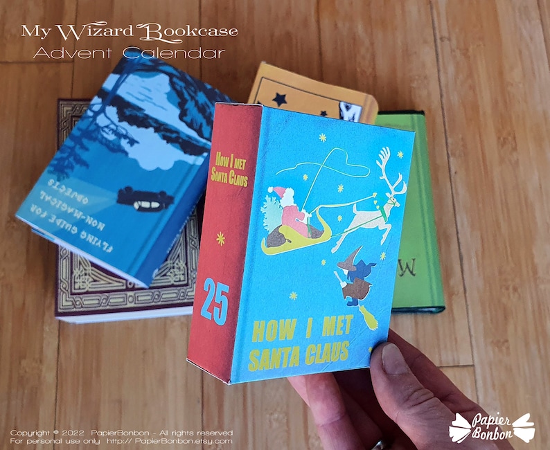 May include: A blue and red miniature book with the title "How I Met Santa Claus" and the number 25 on the cover. The book is part of a wizard bookcase advent calendar.